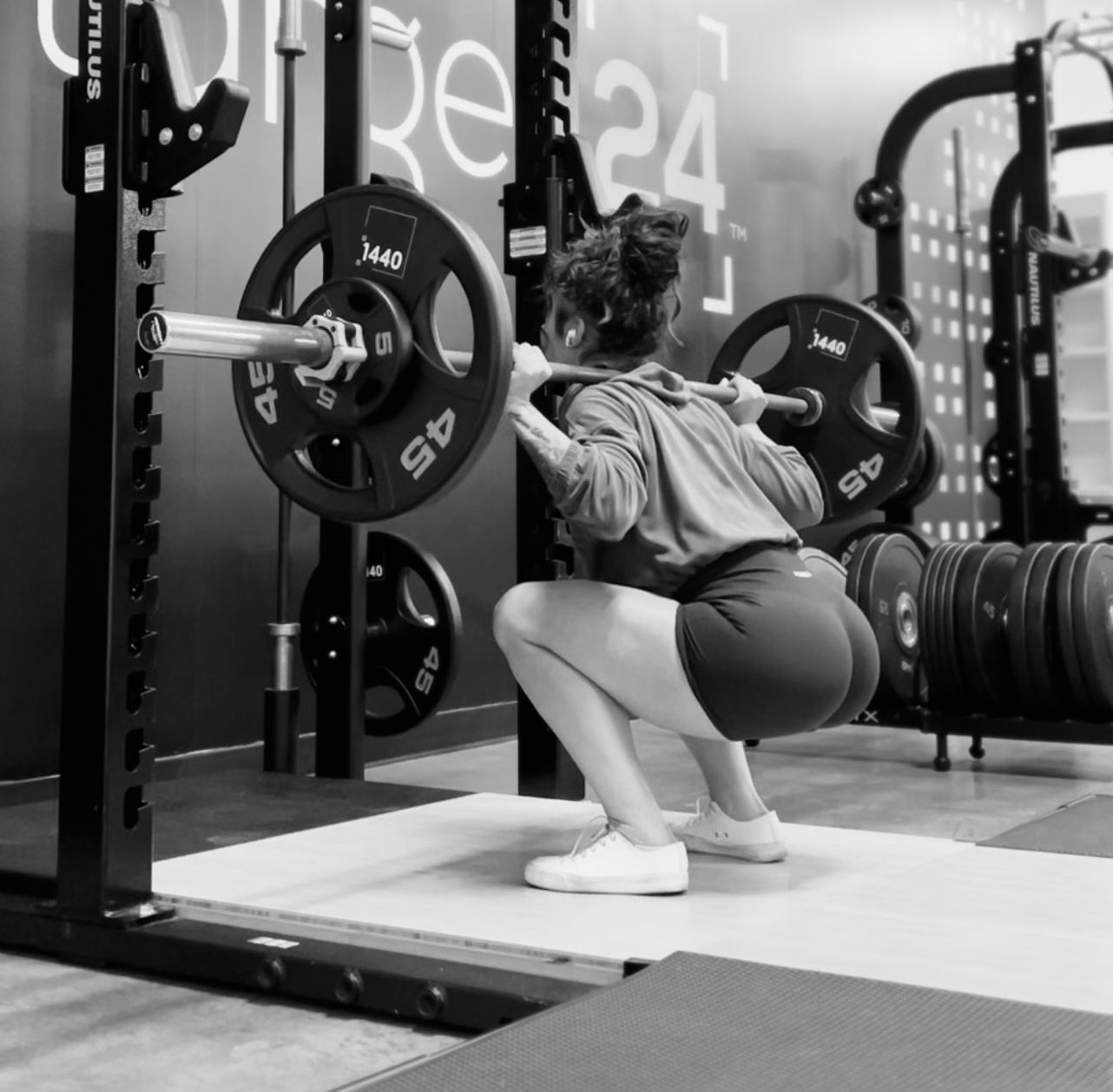Hayley sitting low into a barbell back squat
